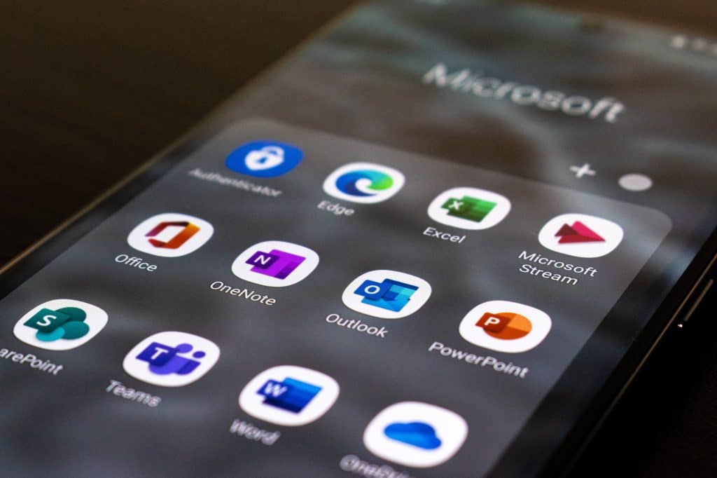 Mobile phone screen showing Microsoft 365 apps such as Teams, OneNote, Outlook
