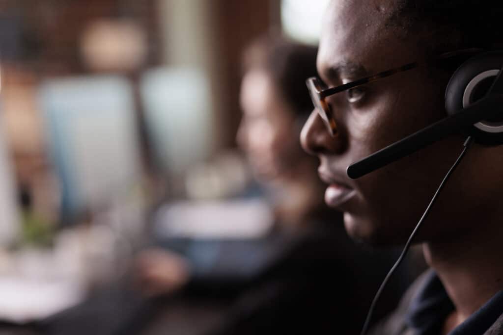 Close up view service desk analysts face with headset